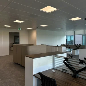 Finished metal ceiling with metal tiles installed in a metal grid system on a commercial fit-out project
