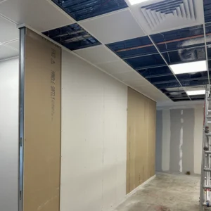 QIC partition wall with LS profile fixed to a suspended ceiling grid and double-skin plasterboard installed