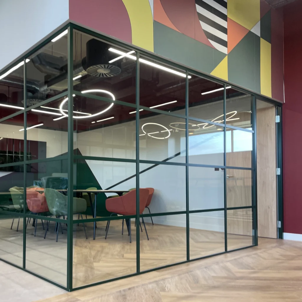 Corner glazed partition with meeting room entrance door and bulkhead detail above
